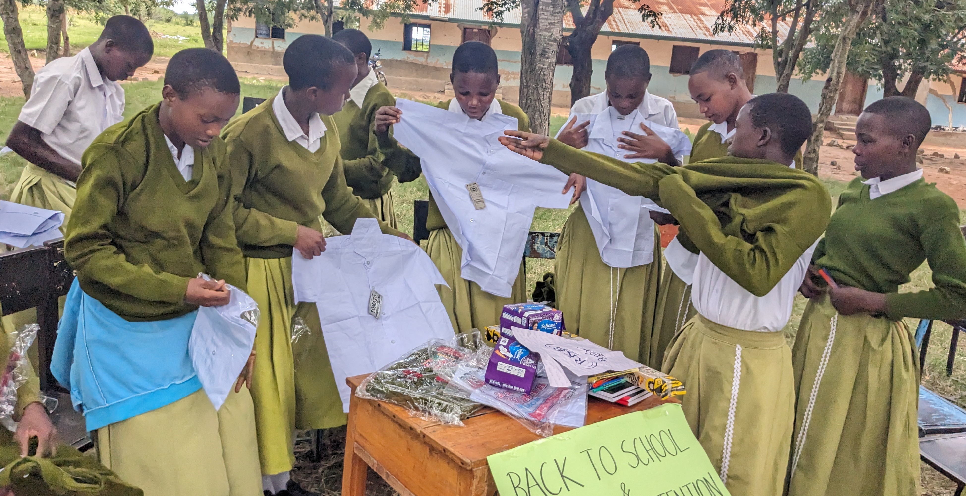 SHEHA PROJECT BENEFICIARIES AT BUJASHI SECONDARY SCHOOL RECEIVING UNIFORMS AND EDUCATIONAL MATERIALS SUPPORT